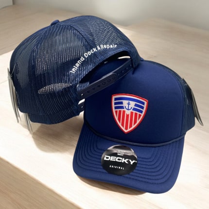 Navy trucker cap by Decky featuring Inland Dock Repair logo.