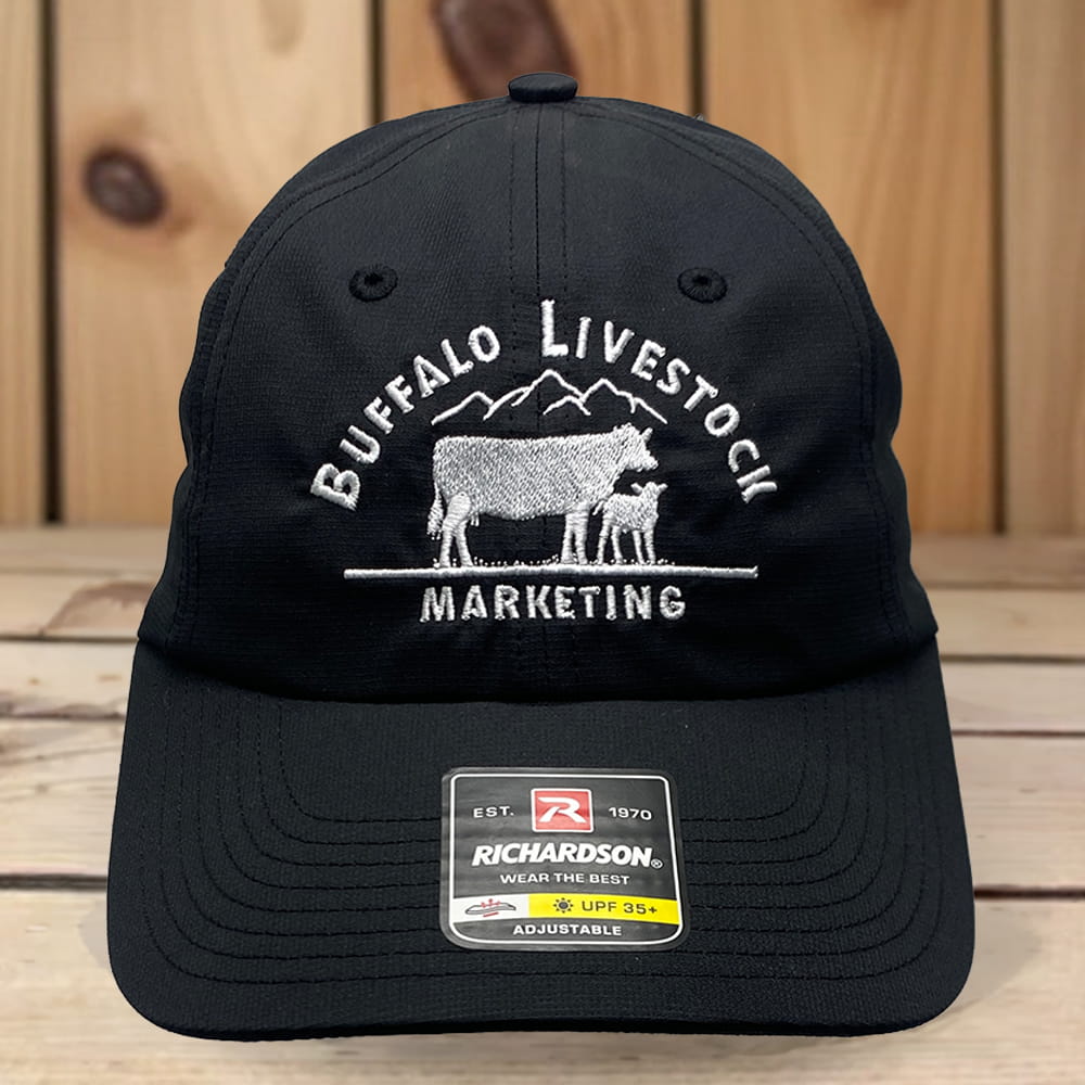 Black Richardson adjustable cap with embroidered Buffalo Livestock Marketing logo, mountains and cow-calf graphic.
