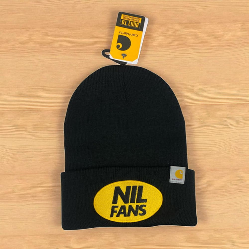 Black Carhartt knit beanie with yellow NIL FANS patch, cuffed winter hat for casual streetwear branding.