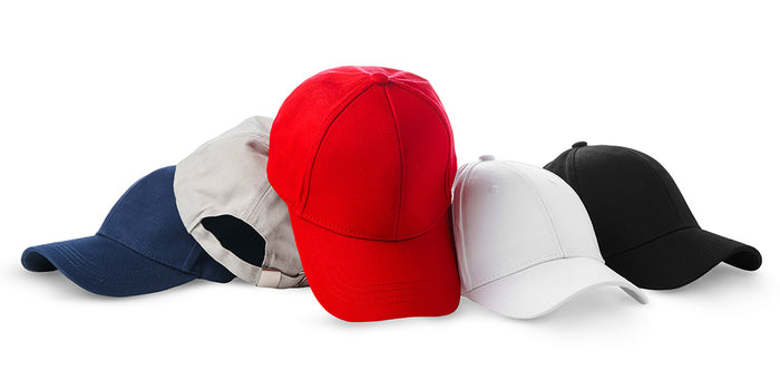Five baseball caps in navy, beige, red, white, and black lined up on a white background.