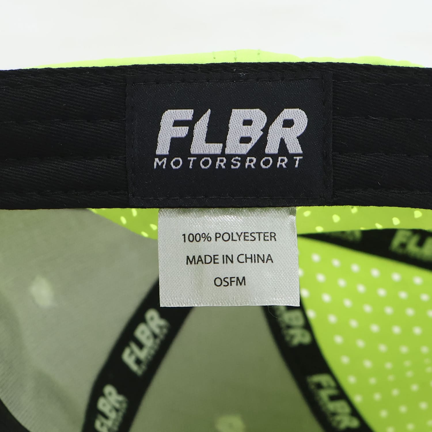 Close-up of inside FLBR Motorsport label: 100% polyester, made in China, OSFM.