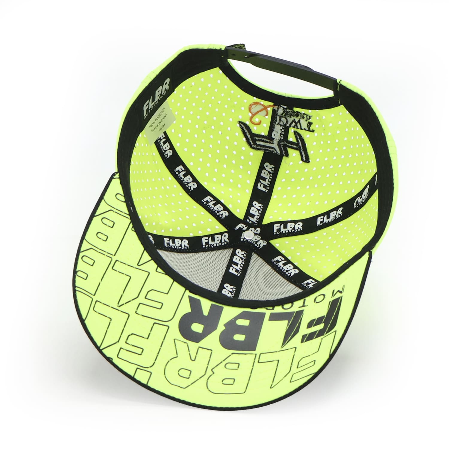 Inside of FLBR Motorsport cap showing lime lining, branded taping, and graphic underbrim print.