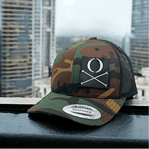 Camouflage snapback cap with a patch of crossed axes.