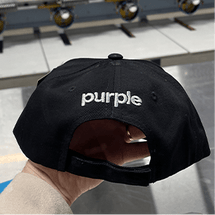 Black cap with 'purple' embroidered on the back.