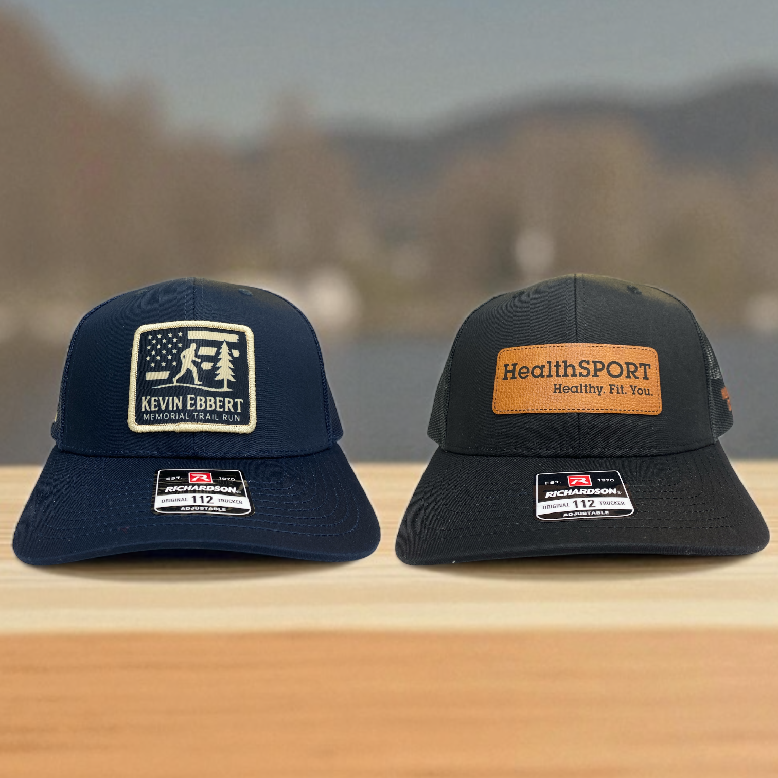 Two Richardson 112 trucker hats: Kevin Ebbert Memorial Trail Run patch and HealthSPORT “Healthy. Fit. You.” patch.
