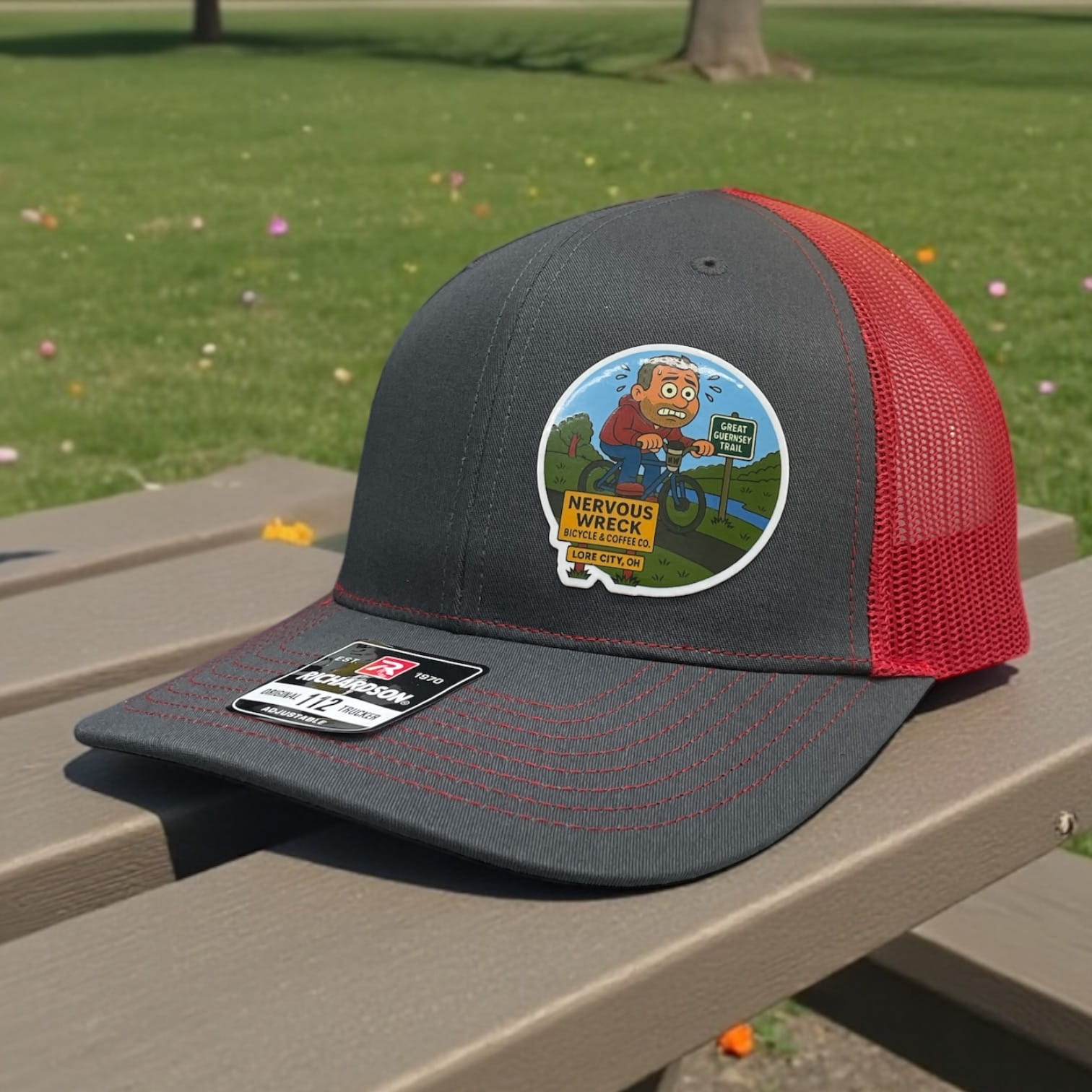 Gray Richardson 112 trucker hat with red mesh and Nervous Wreck Bicycle & Coffee Co. Lore City, OH cartoon patch.