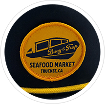 A black cap with a yellow circular patch that reads "Buoys & Gulls Seafood Market Truckee, CA".